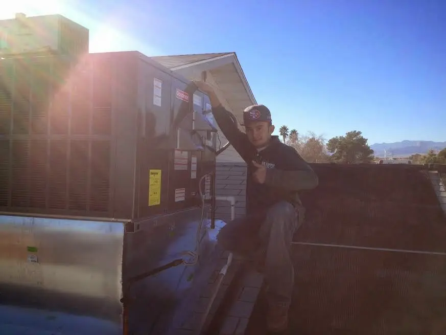 HVAC technician performing AC Tune-Up on a rooftop unit in Loudoun Valley Estates